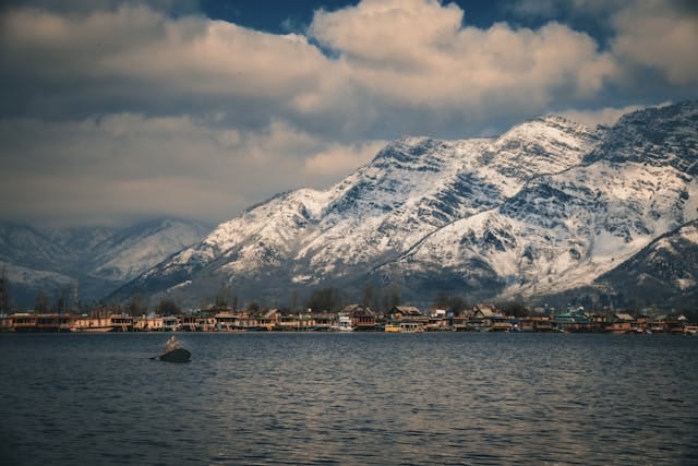 Dal Lake in winter with snow-covered Mountains in background