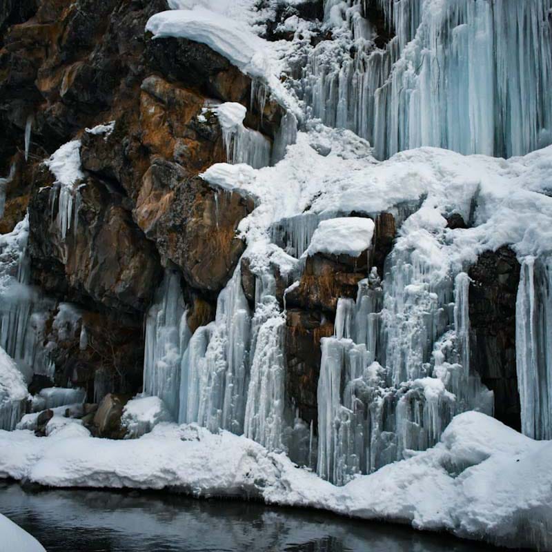 Frozen Drung Waterfall with cascading ice formations against rugged cliffs