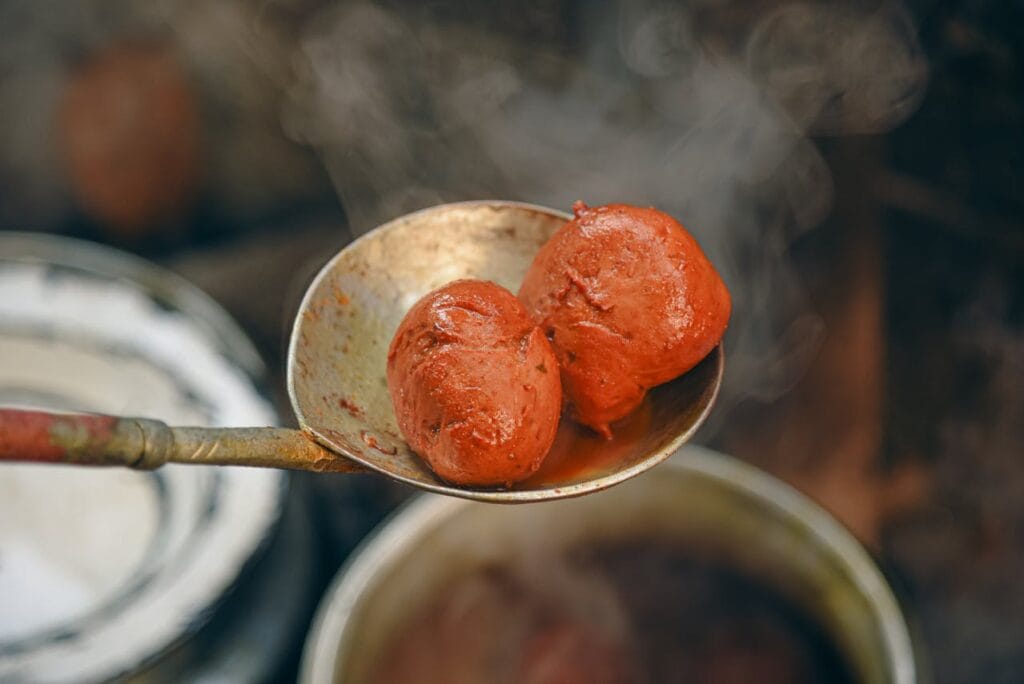 Two RIsta(Meatballs) in a big Copper Ladle in Kashmir