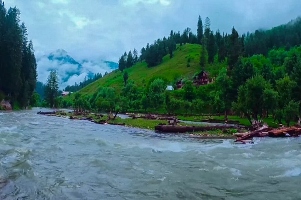 A picturesque view of Keran Valley with flowing river, lush green forests and mountains